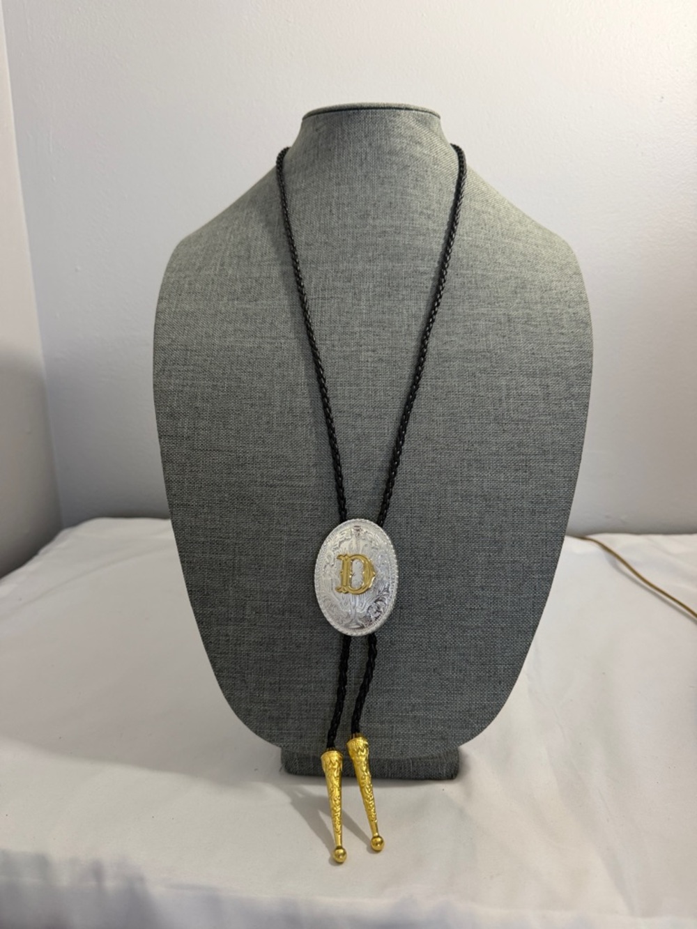 Monogram 'D' Western-Style Black Bolo Tie with Gold Tips